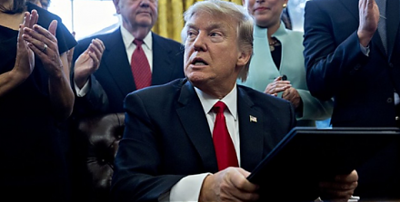 President Trump signs an executive order to freeze federal employee pay in early-2019.